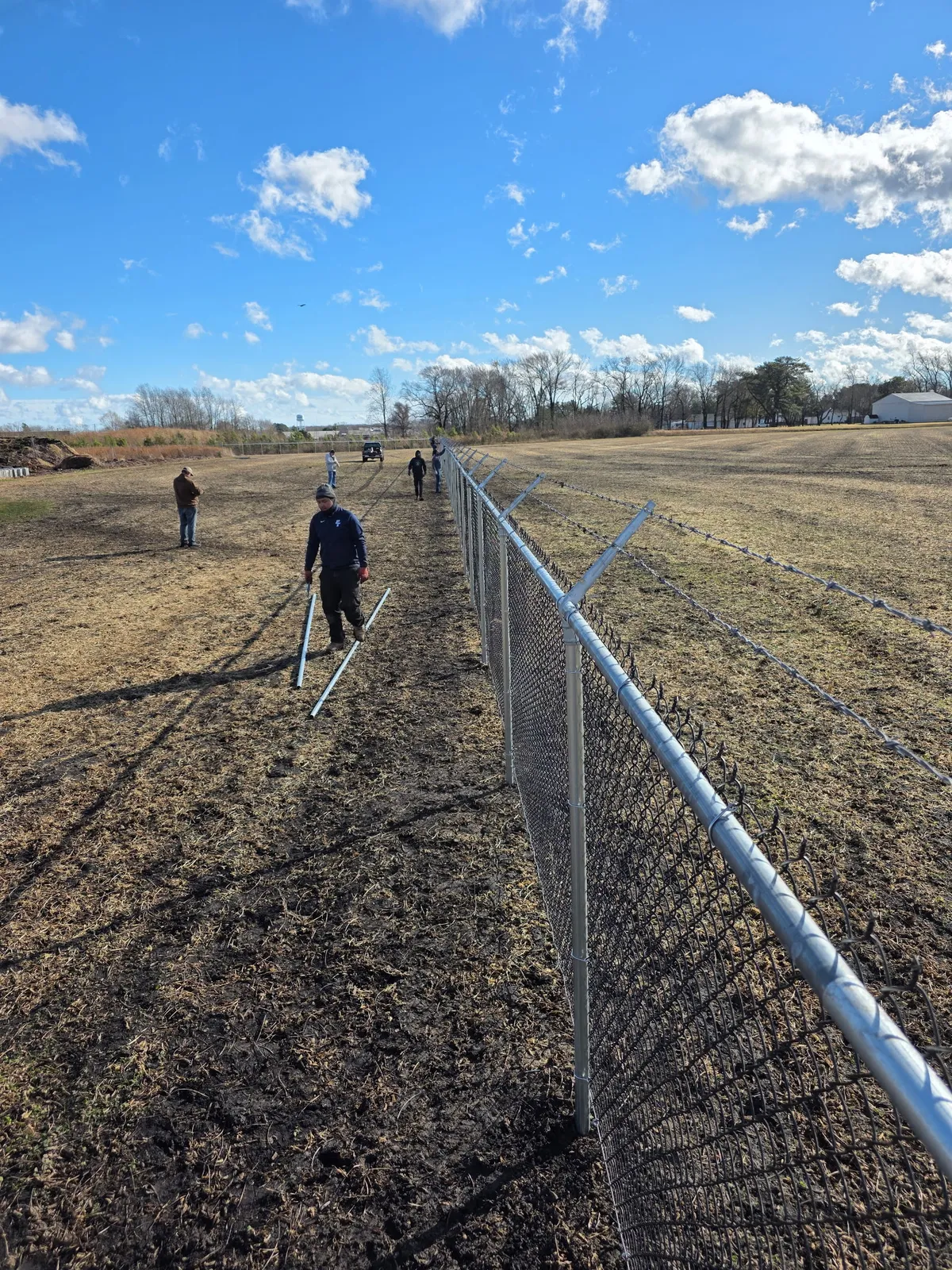 Galvanized chain link fence installation on large property