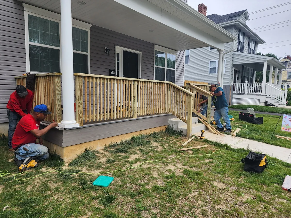 TWO MEN construction crew building custom porch railing