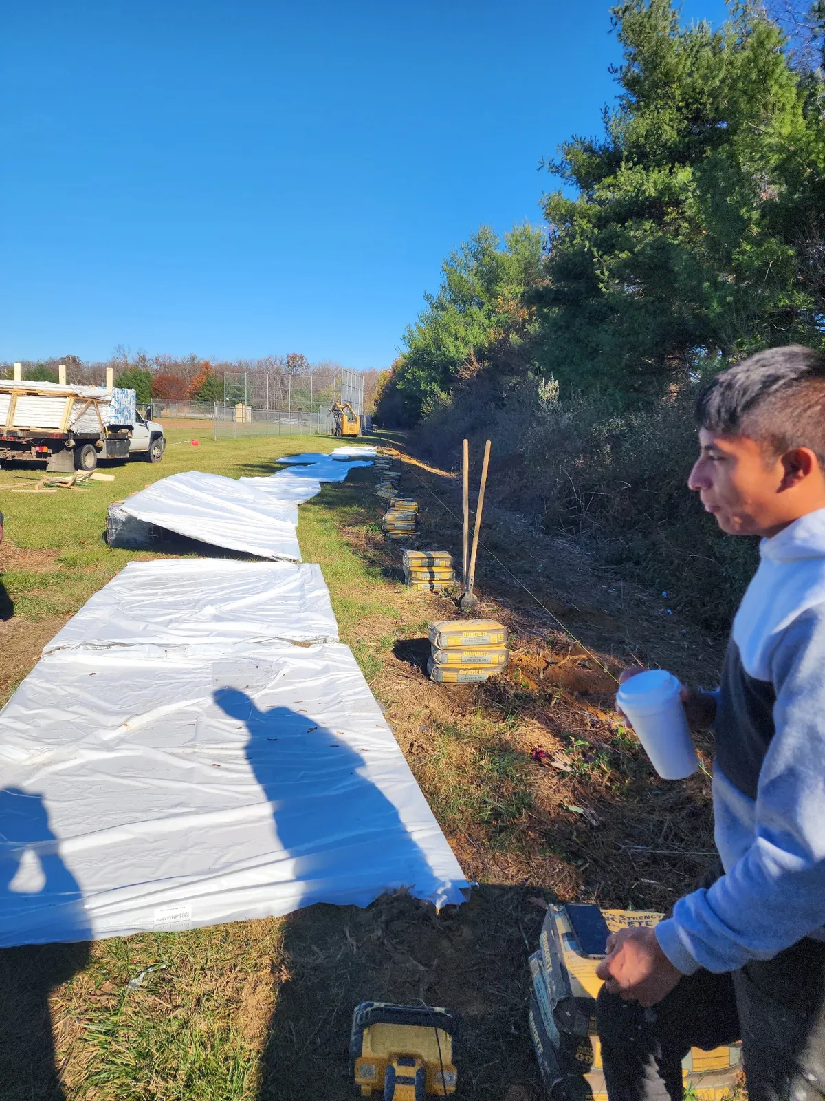 Vinyl fence materials being prepared for installation on job site